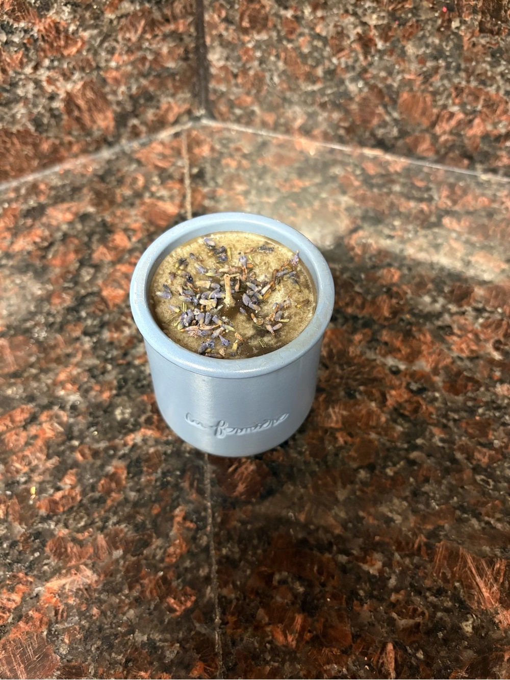 Upcycled candle vanilla scented wax in a repurposed jar with lavender pieces